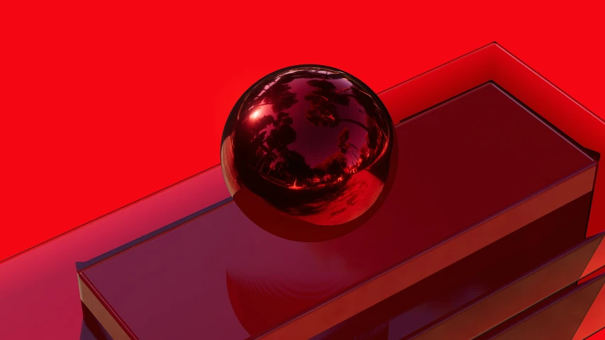 a metal ball sits on top of a red surface