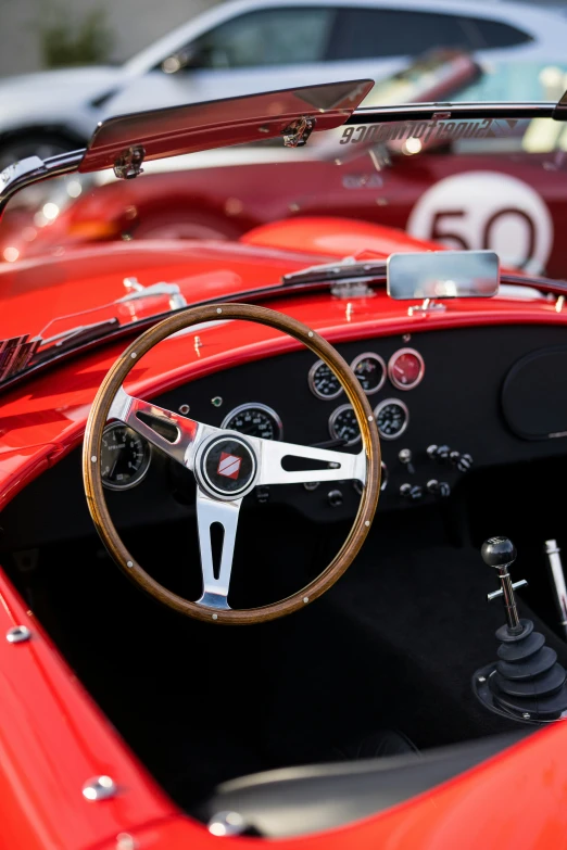 the inside of a car with leather seats and wooden steering wheel