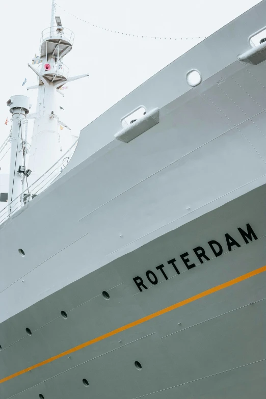 a big, grey boat with a white lighthouse on top