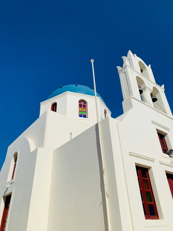 the building has a large blue roof and two windows on the tower