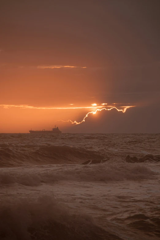 a sun shining through clouds in the distance