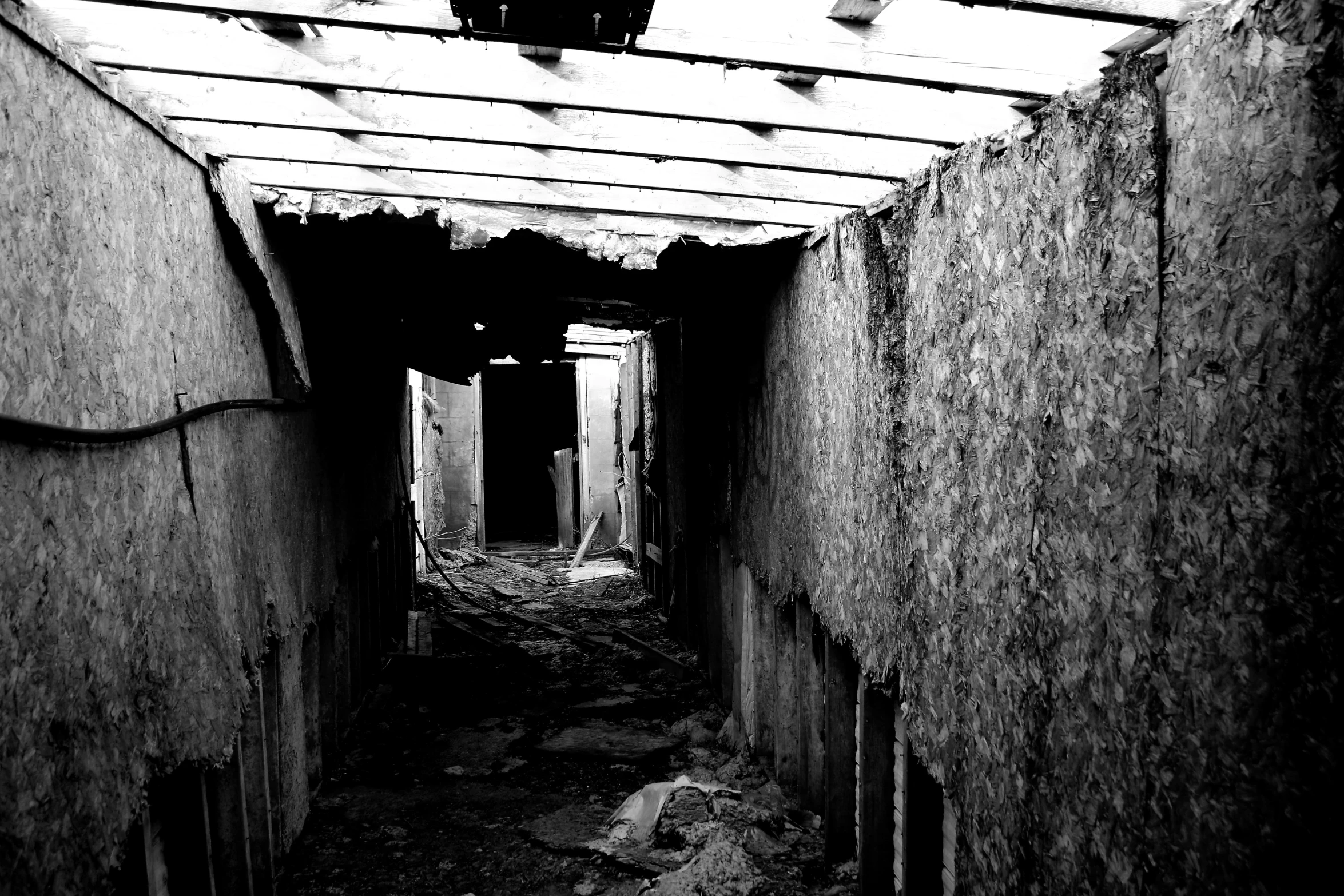 a black and white picture of a hallway with no doors