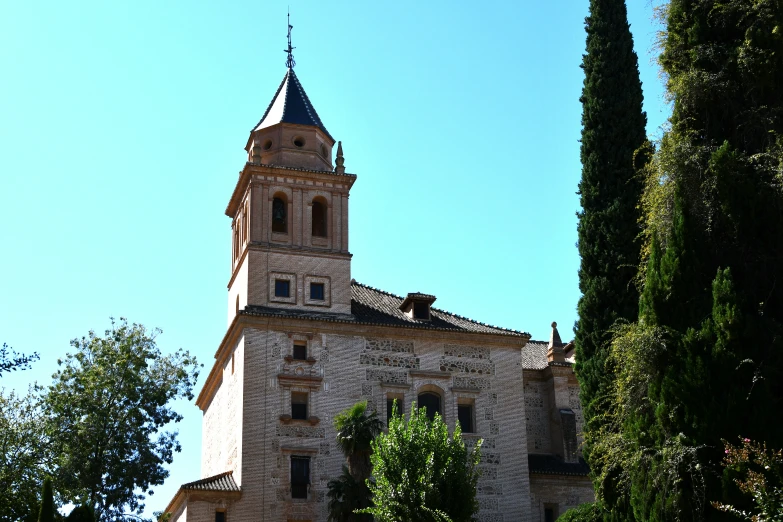 an old building with a tall steeple and a clock on the tower