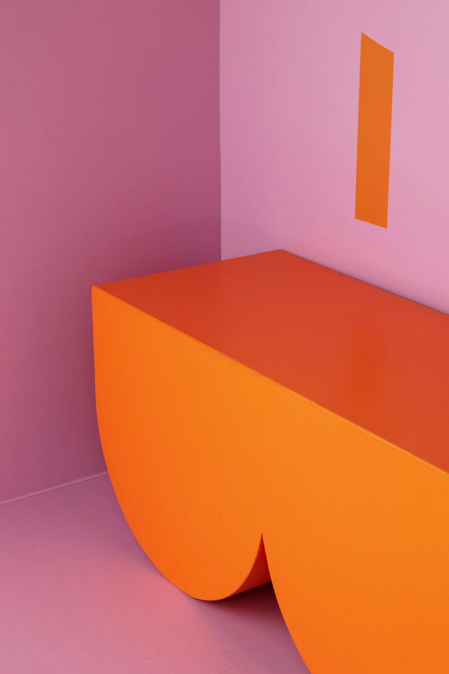 an orange bench is positioned beside a purple wall