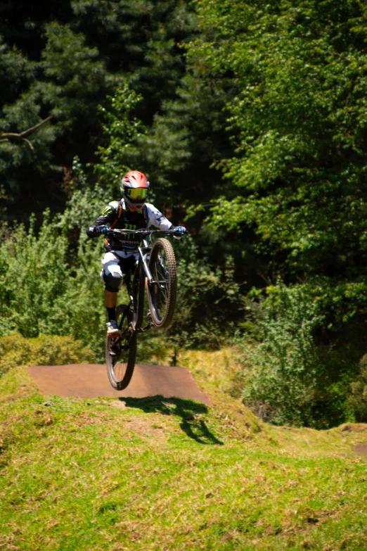 a man riding a bike down a small ramp