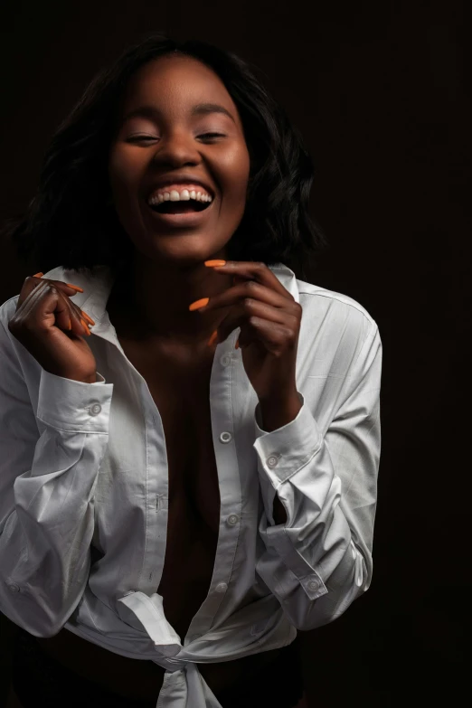 a women wearing a white blouse laughing and holding a cigarette