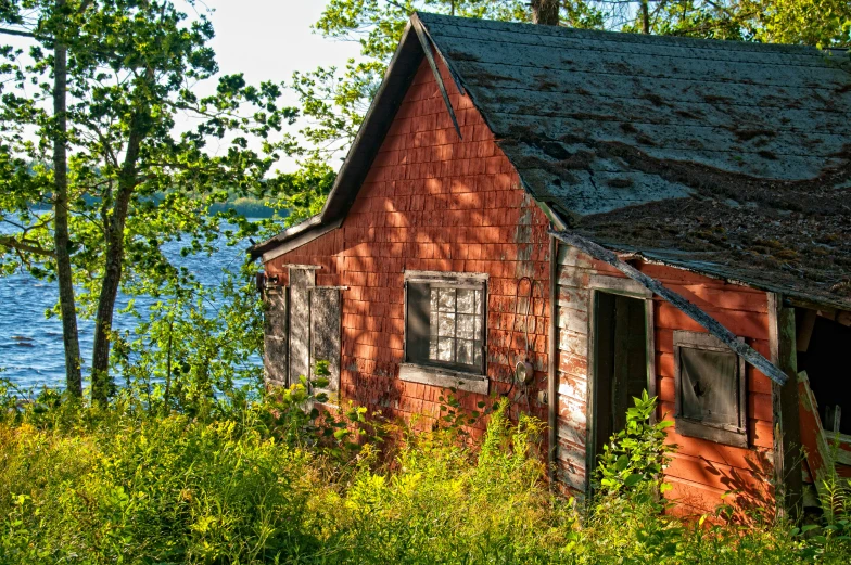 a red building sitting next to a body of water