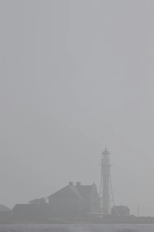 the view of the lighthouse is shown from across the water