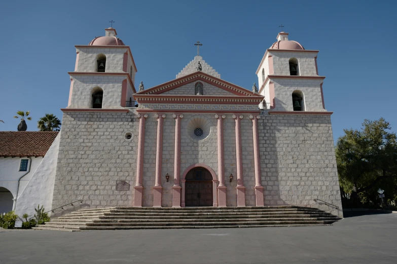 a church with stone steps and steeples next to it