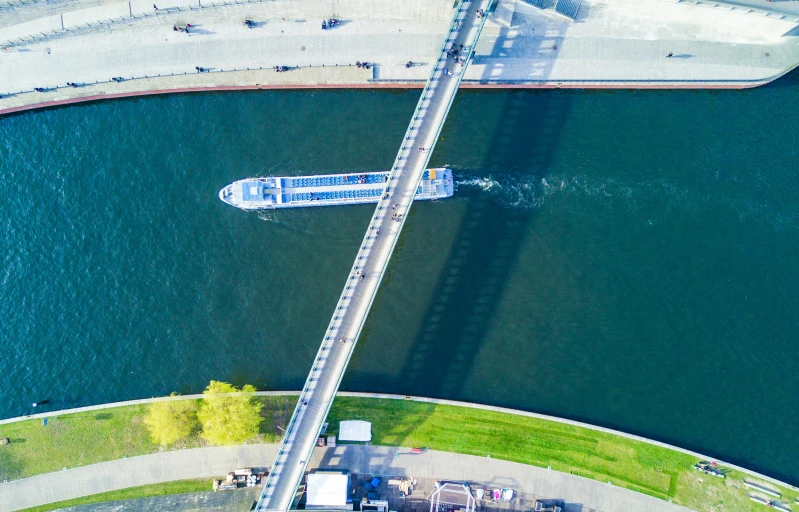 a boat is on the water near an elevated bridge