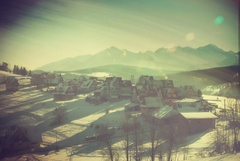 an over head s of a small town with mountains in the background