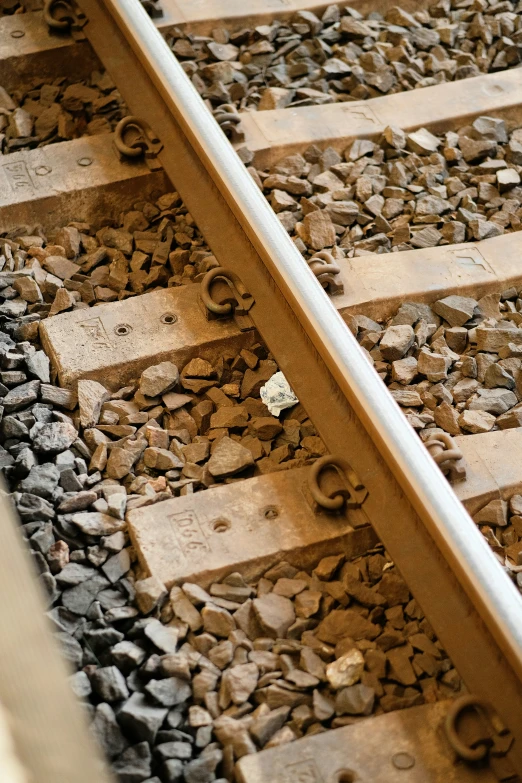 a railroad track with various rocks and pebbles between it