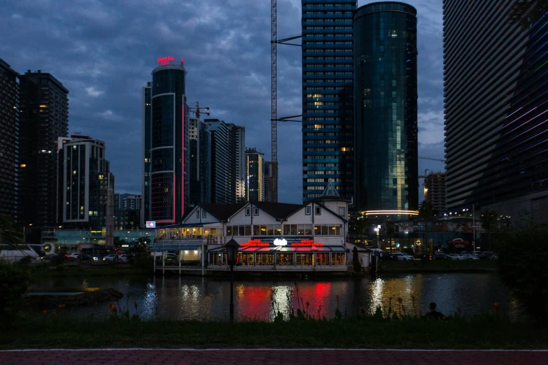 a boat on the river with many tall buildings