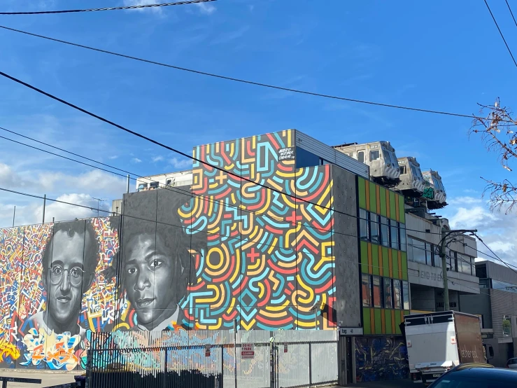 the mural on the side of a building depicts two people, a man, and a woman