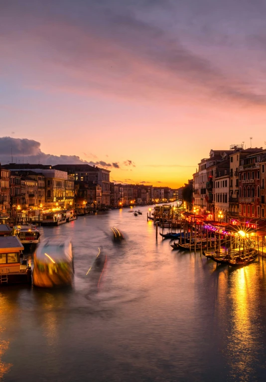 colorful lights on a waterway during the sunset