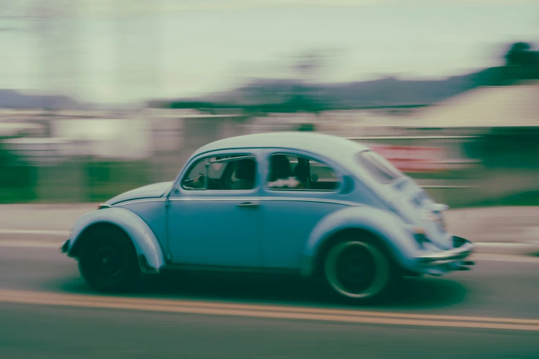 an old vintage car on the road during the day