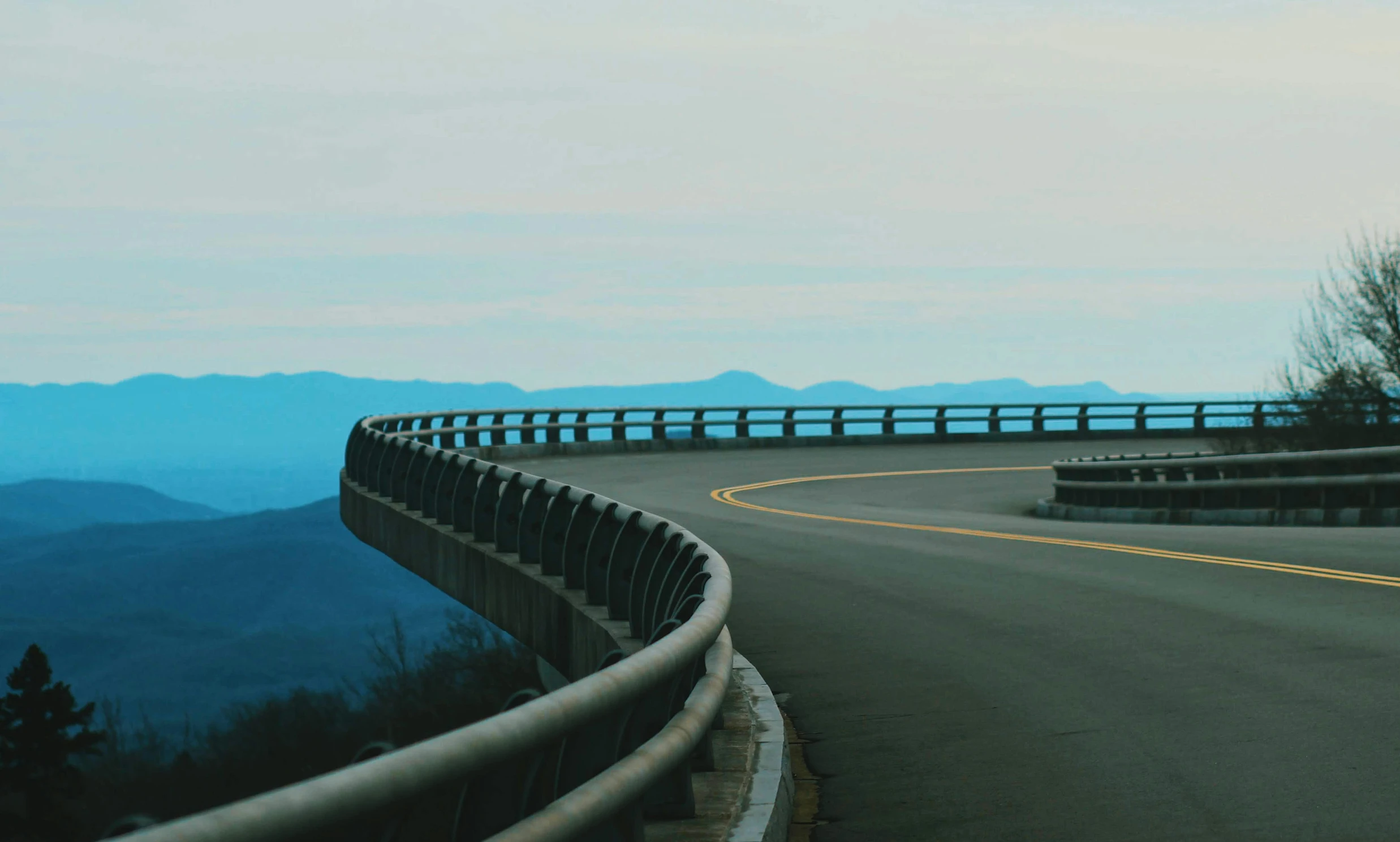 the winding road leads down to a scenic mountain view