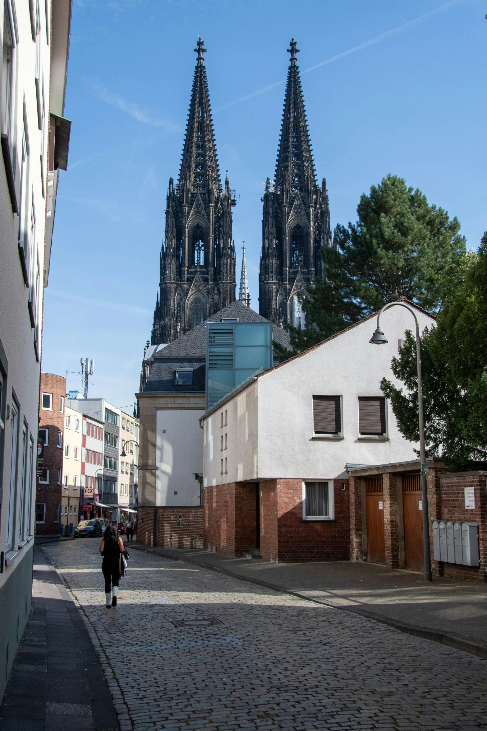 an alley way with buildings and a man walking down it