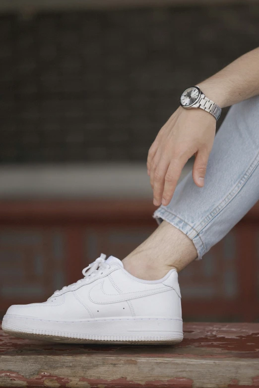 a white shoe is sitting on top of the wooden table