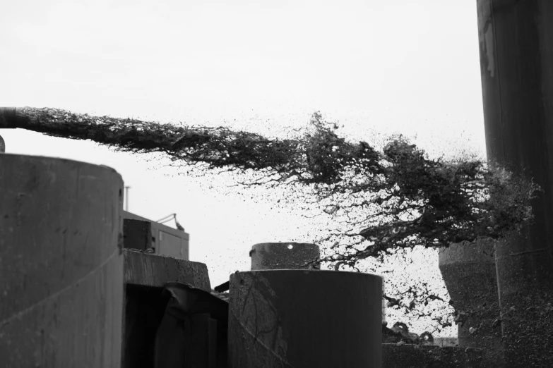 black and white pograph of water leaking from a pipe