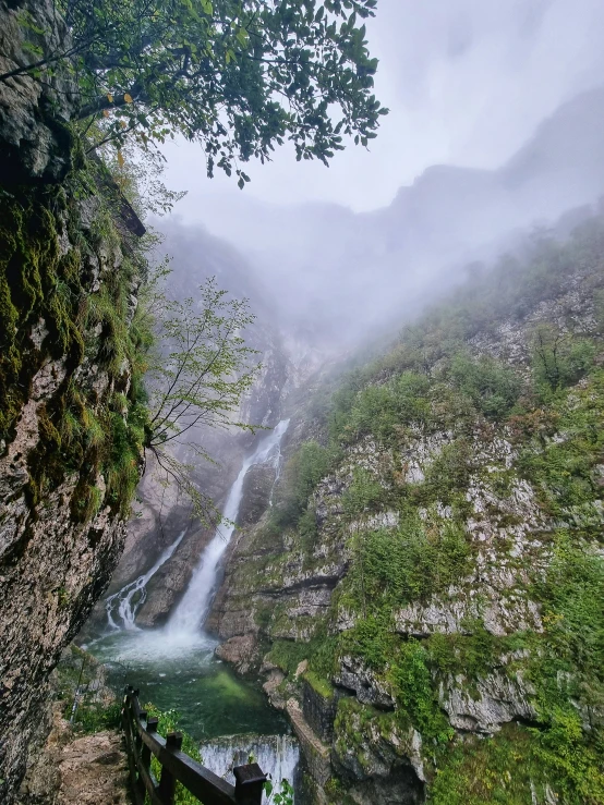 a waterfall with water coming down it from a cliff