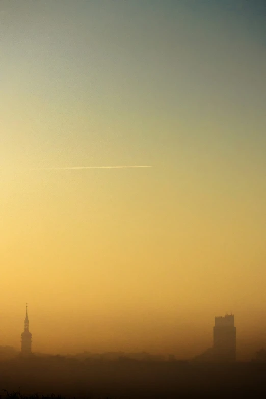 an airplane is flying over the city with tall buildings