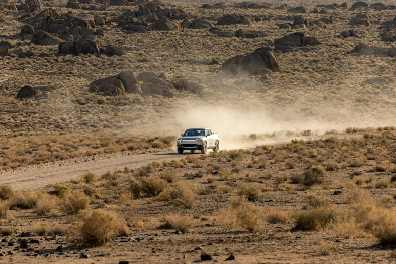 an off road car on dirt road through a field