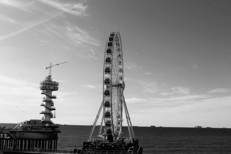 there is a ferris wheel sitting next to the ocean