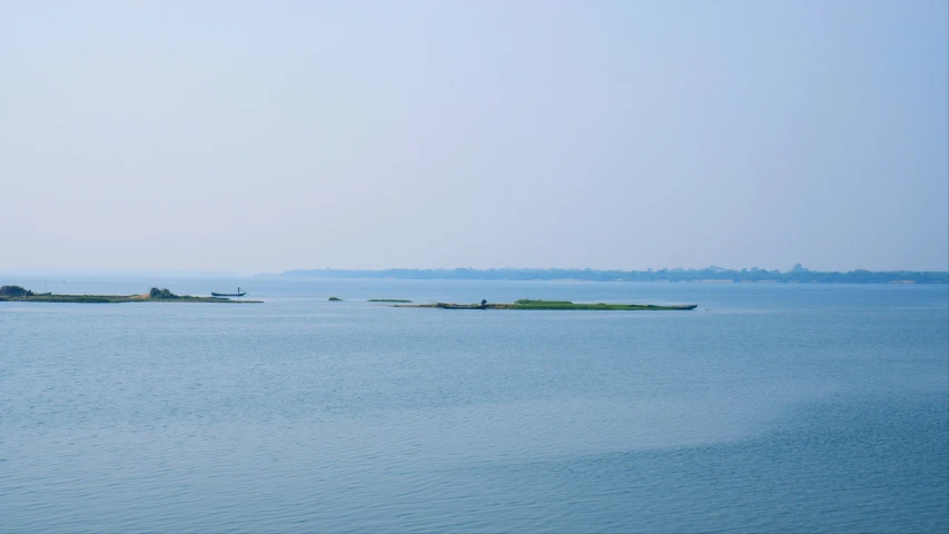 some boats sailing on a big lake