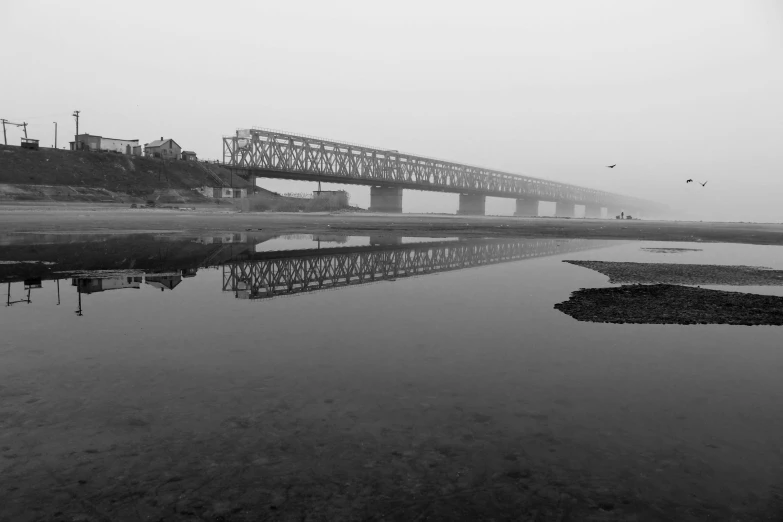 bridge reflection of the water with no clouds