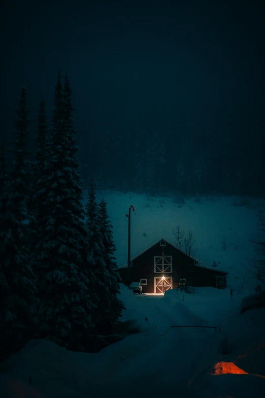 a cabin in the woods lit up by a bright light