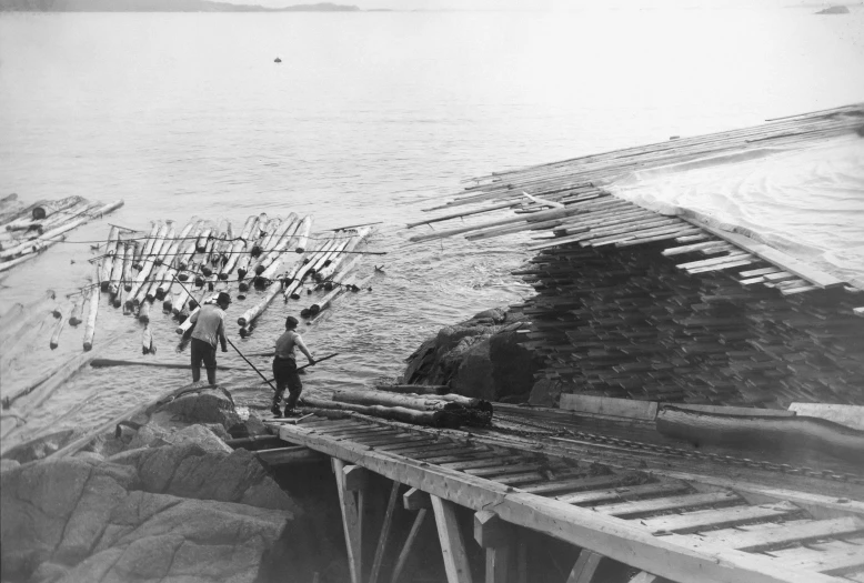 old time picture of a group of men standing on a dock