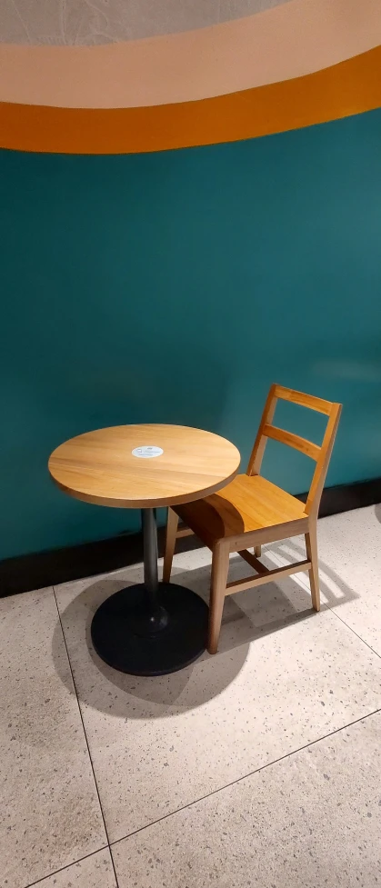 a round table with a small wooden chair by it