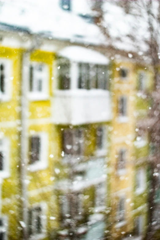 the view through the window of a snowy city building