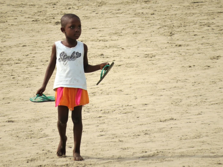 a  in white shirt holding a green kite