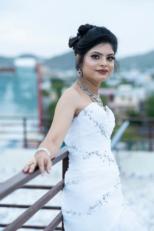 young woman in white dress posing for picture