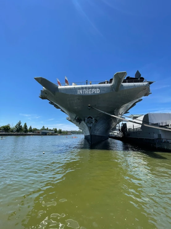 a plane flying over the water while docked