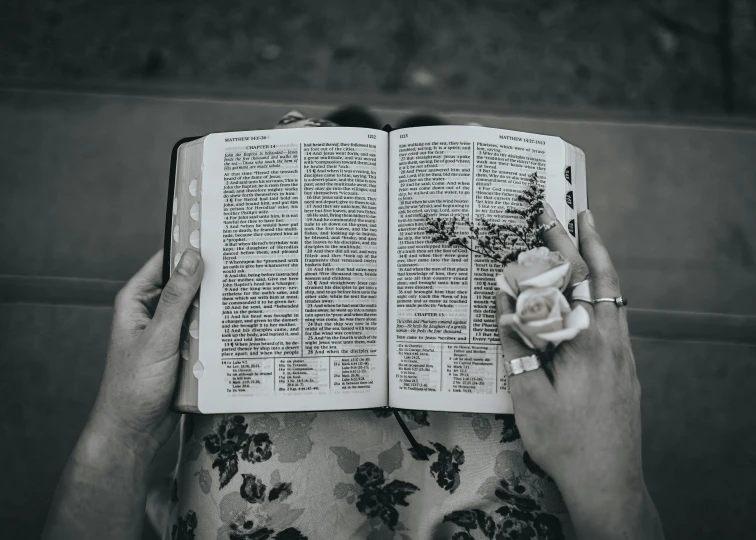 a black and white po with an open bible