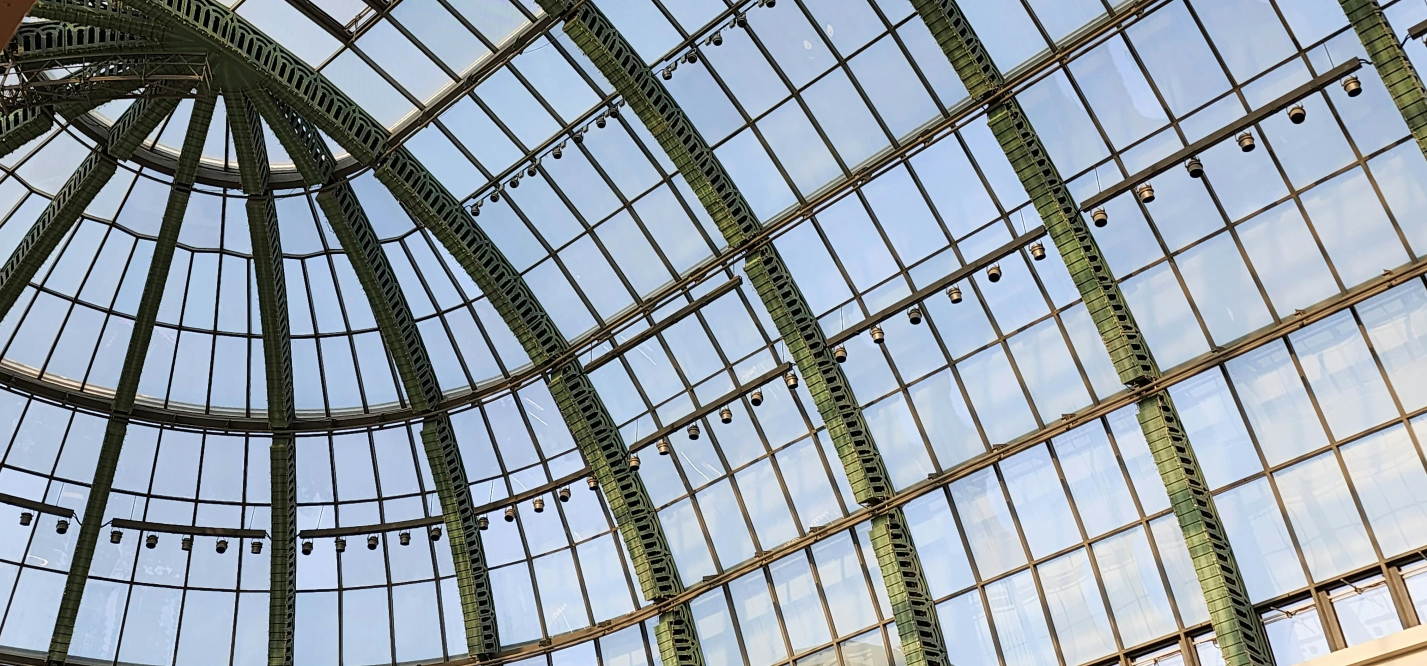 large roof with glass windows in front of sky