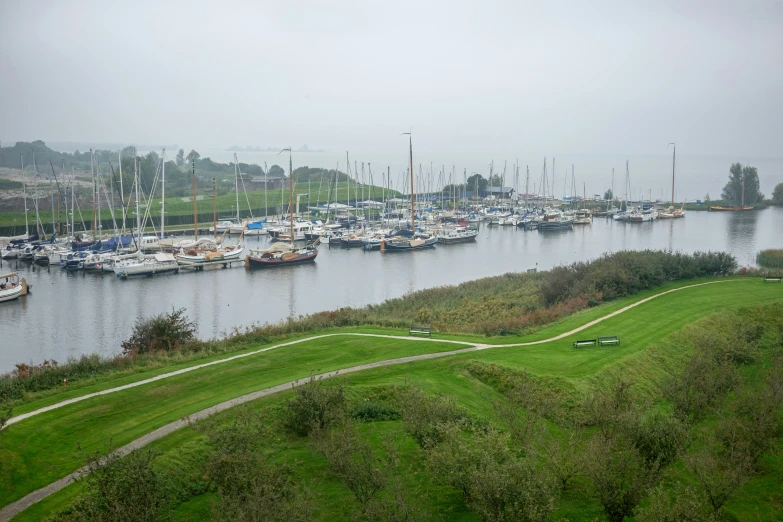 the harbor on a cloudy day with boats in it