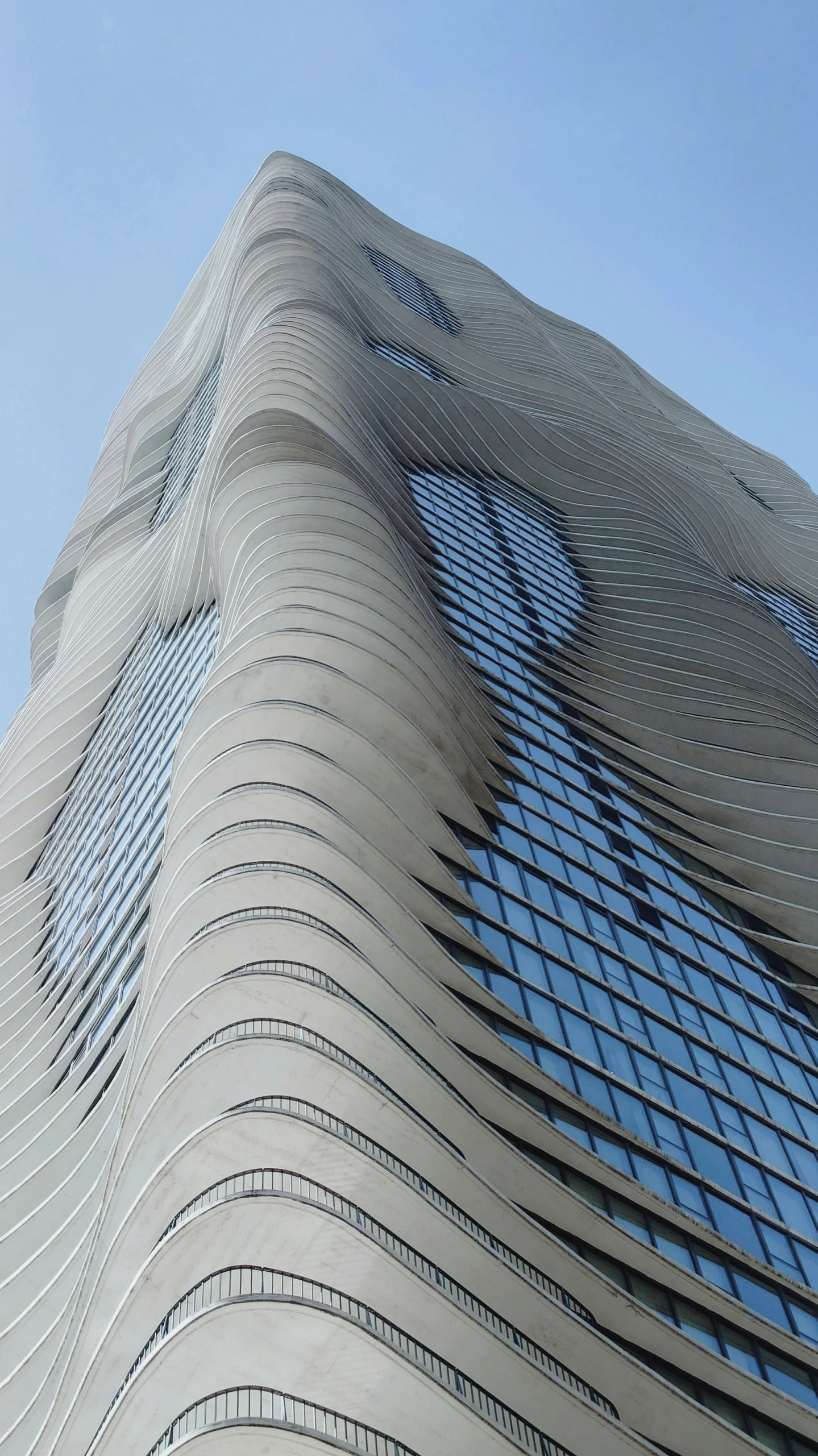 a tall building with windows and a clock on it