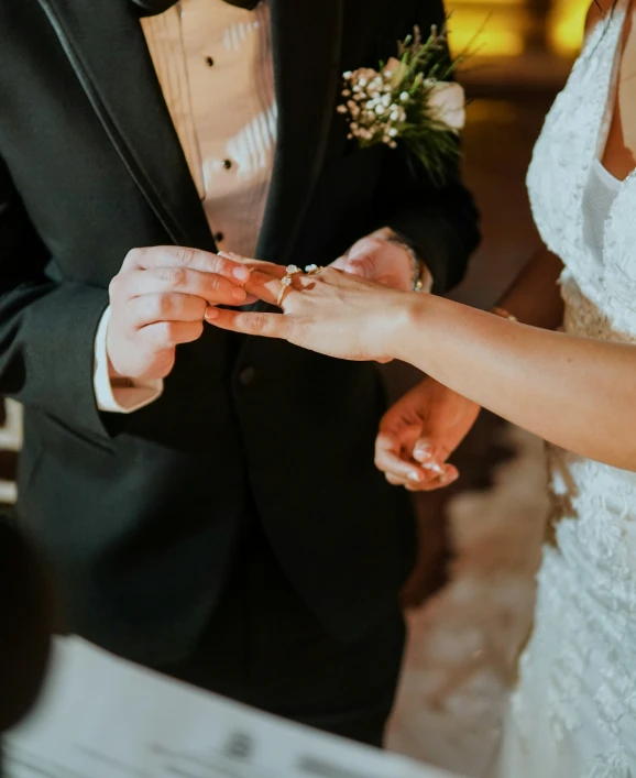 a man holding a piece of paper with another hand