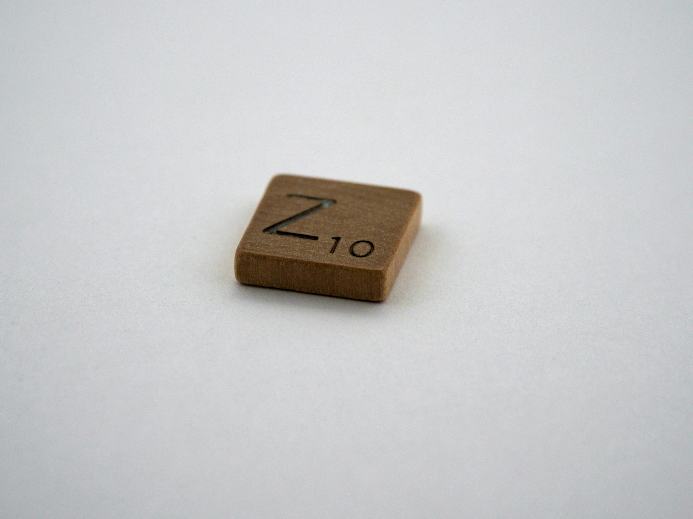 a wooden square with an arabic numeral on it