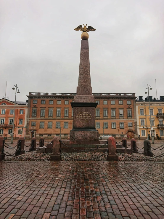 a tall monument with a bird statue on top of it