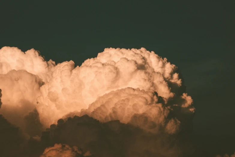 an airplane flying in the air over clouds