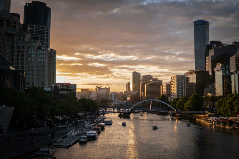 a city with tall buildings is shown at sunset