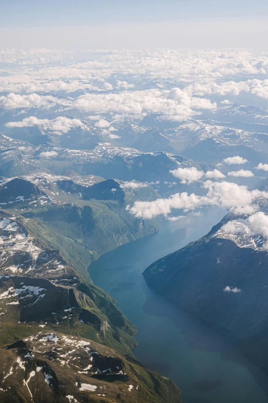 an aerial view from an airplane looking down on mountains and lake