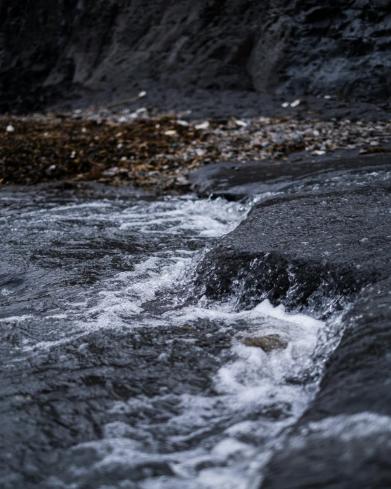 a stream of water running under some rocks