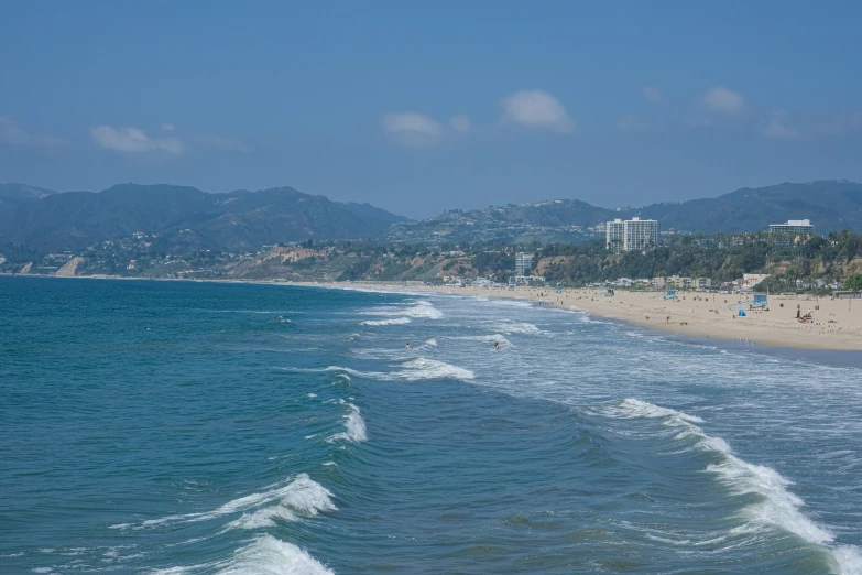 there are several people at the beach in the water