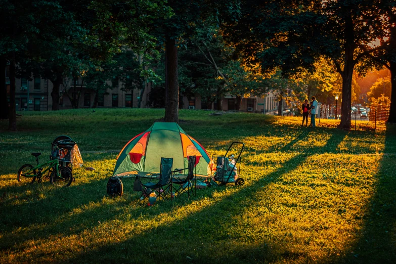 the camping tent is lit up with a bike